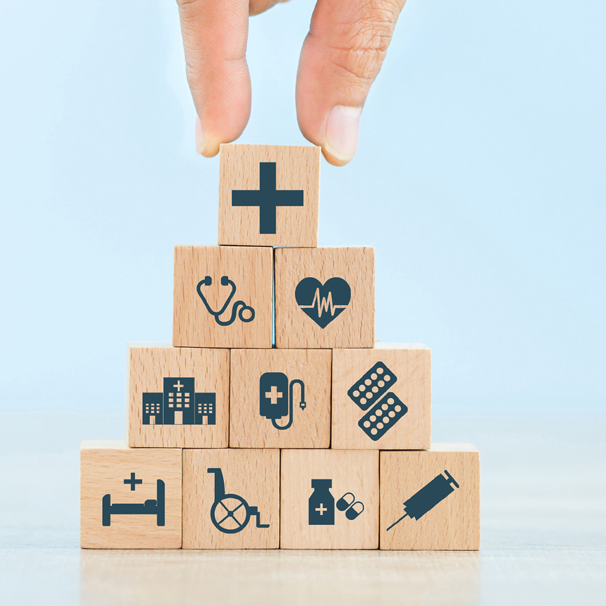 Hand with building blocks of healthcare icons