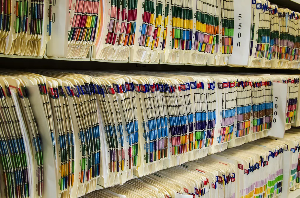 Bookshelves full of patient charts.