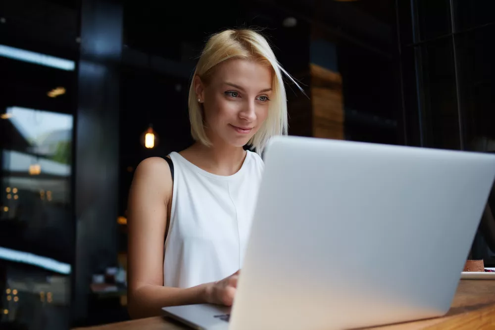 Young woman studying how to apply on her laptop.